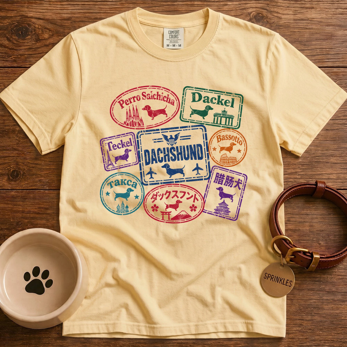 Butter colored Dachshund t-shirt design with passport stamps reading dachshund in Spanish, German, French, Italian, Russian, Japanese and Chinese