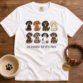 White Comfort Colors t-shirt with a “Dachshund Variety Pack” graphic of eight cartoon dachshunds in different coats and colors, including black and tan, red, cream, chocolate, dapple, piebald, longhaired, and wirehaired.